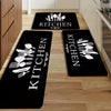 Black non-slip flannel area rugs with white cutlery designs placed on a light wood floor.