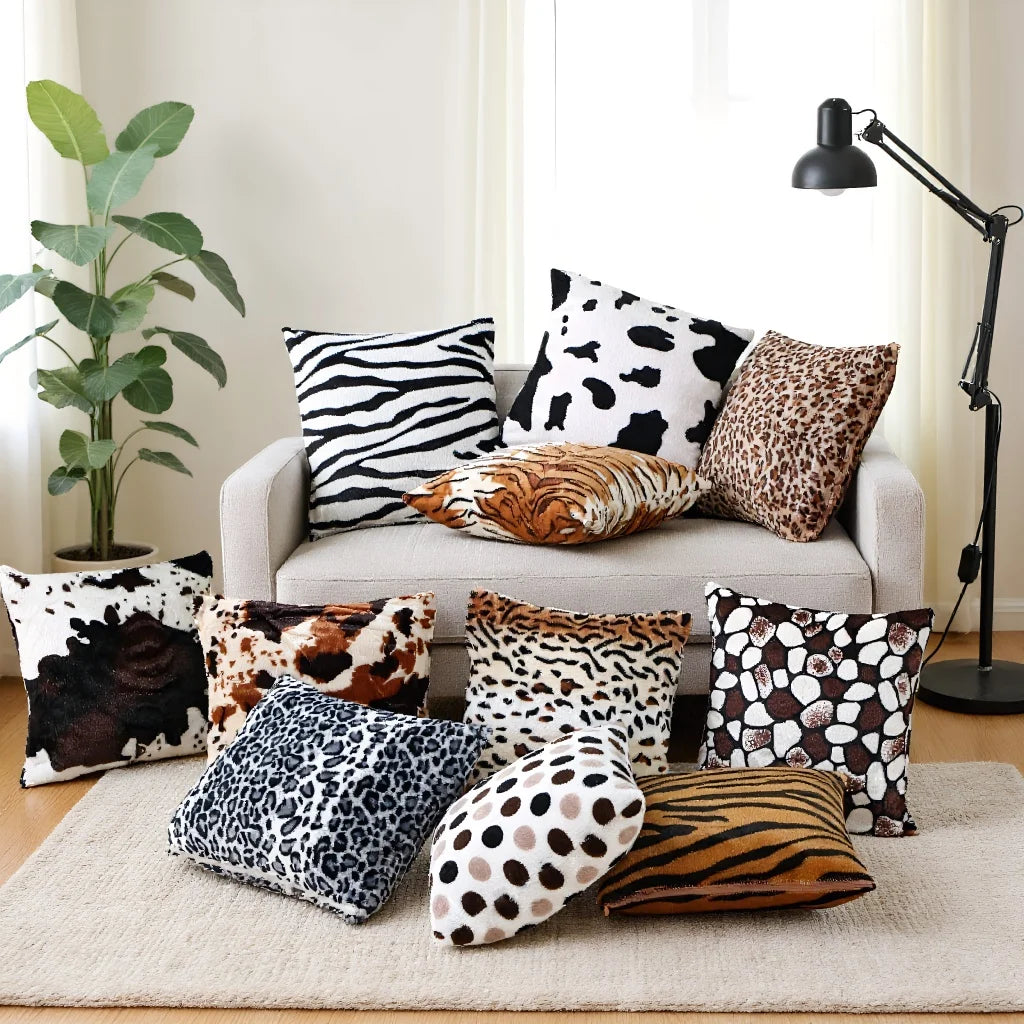A collection of leopard print throw pillow covers in various shades and patterns displayed on a beige rug.