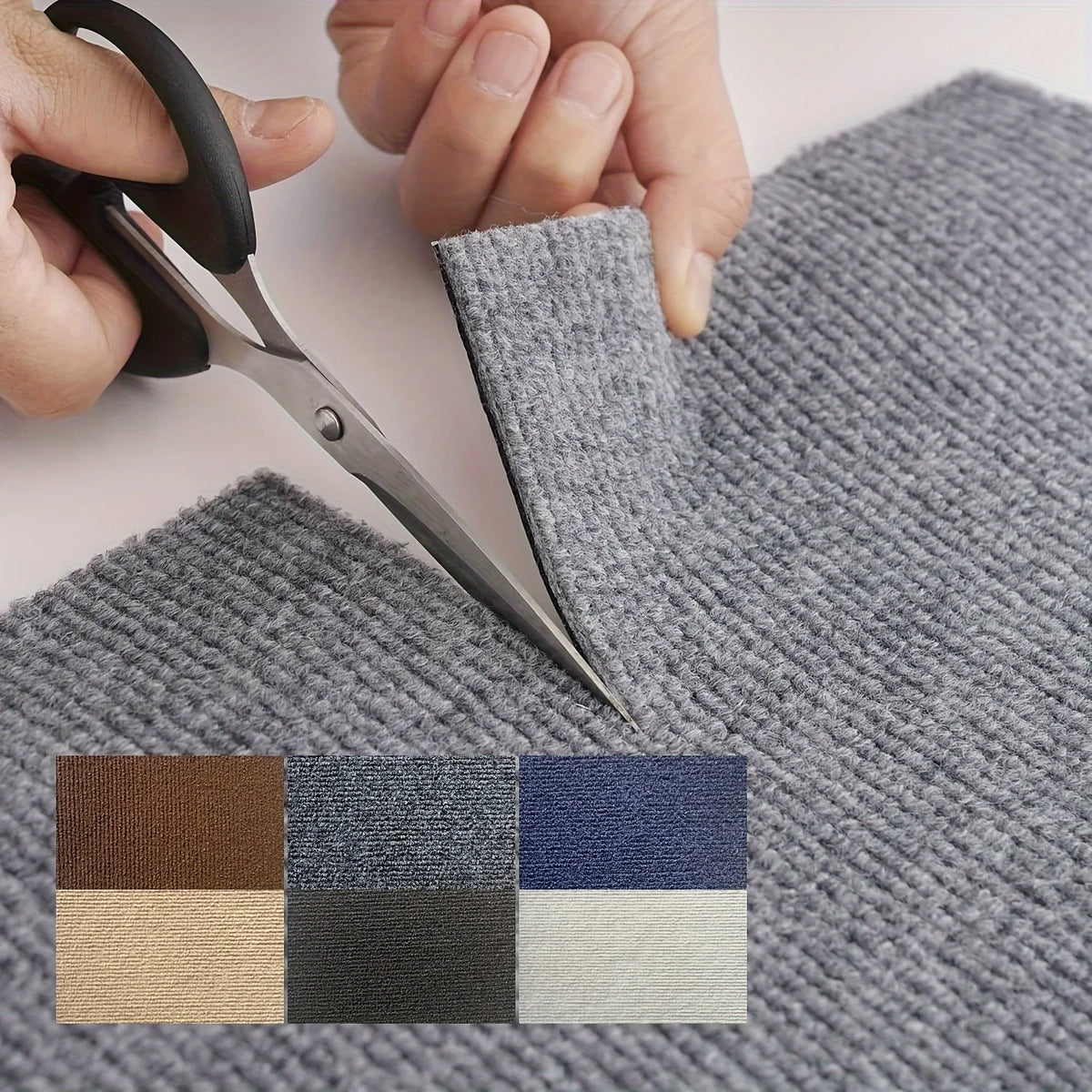 A hand is using scissors to cut a gray carpet tile, next to a swatch of various colored square tiles.