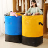 A pair of heavy duty waterproof storage bags, one blue and one yellow, sitting on a floor.