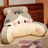 A light gray and white plush sofa cushion shaped like a cute animal face with pink accents.