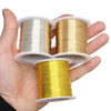 A hand holds three spools of bendable copper clad steel wire in silver, gold, and yellow tones.