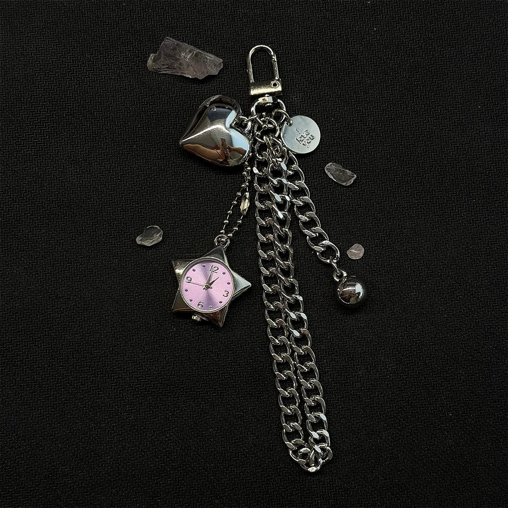 Silver chain keychain featuring a heart charm and a pink-faced pocket watch with a star shape.