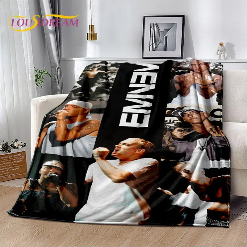 A black and white graphic throw blanket featuring images of Eminem.