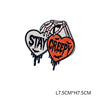 Iron-on patch featuring a hand shape with the text STAY CREEPY embroidered in orange and black thread