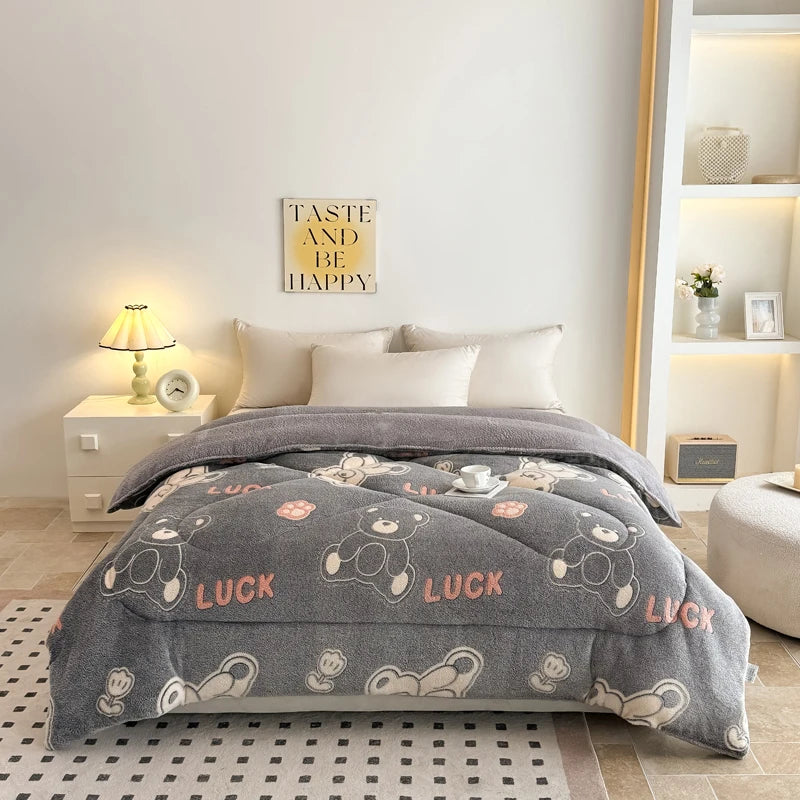 A gray lamb'swool winter blanket is spread on a bed, decorated with luck motifs, in a bright bedroom setting.