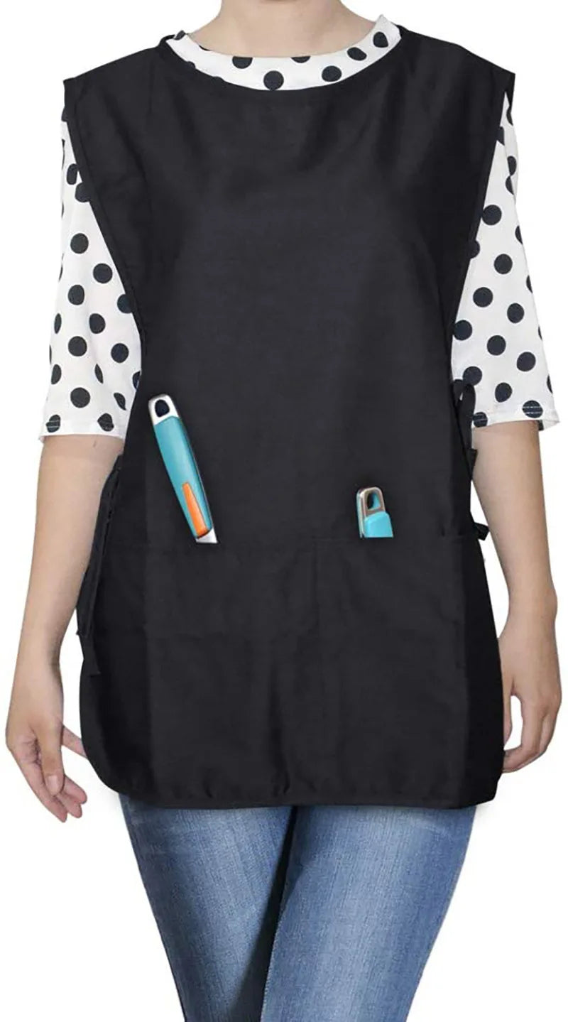 Black polyester apron with white polka dots and blue accents worn by a person.