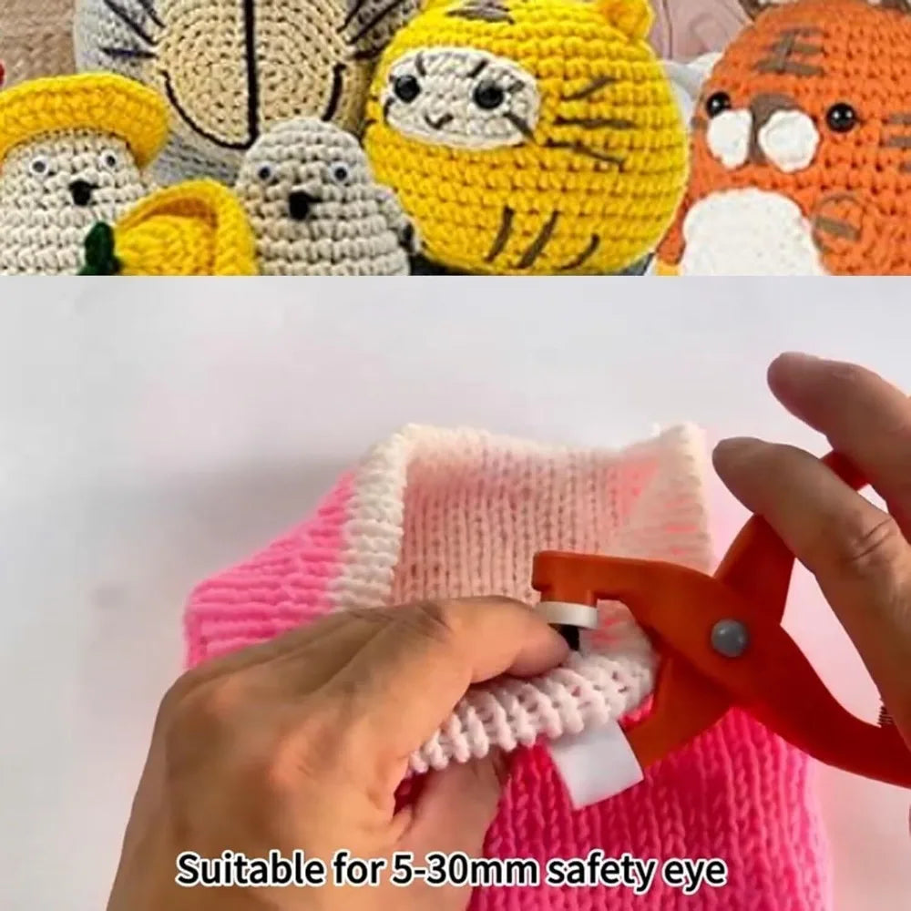 Hands are using orange crimping pliers to attach a safety eye to a pink crocheted item.