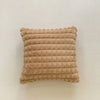 A rectangular, textured beige plush winter throw pillow cover.