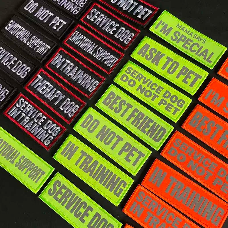 A collection of black, red, and lime green embroidered patches with various phrases like Do Not Pet, Service Dog, and In Trai
