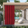 A vibrant red waterproof outdoor curtain with a grommet top hanging in a wooden pergola setting.