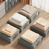 Gray storage boxes filled with neatly folded beige non-woven fabric for bedding and clothing
