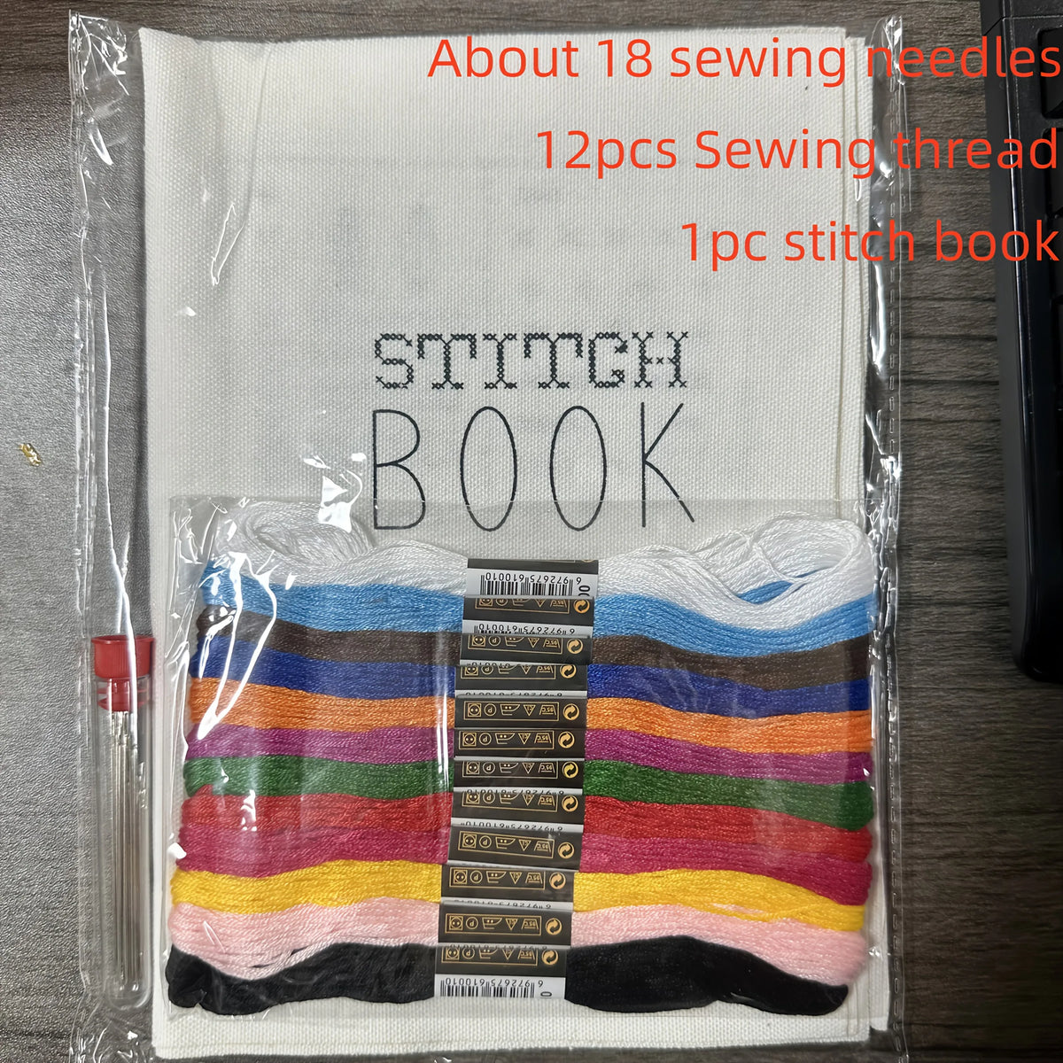 A clear plastic package containing about 18 sewing needles, 12 pieces of sewing thread in various colors, and one stitch book