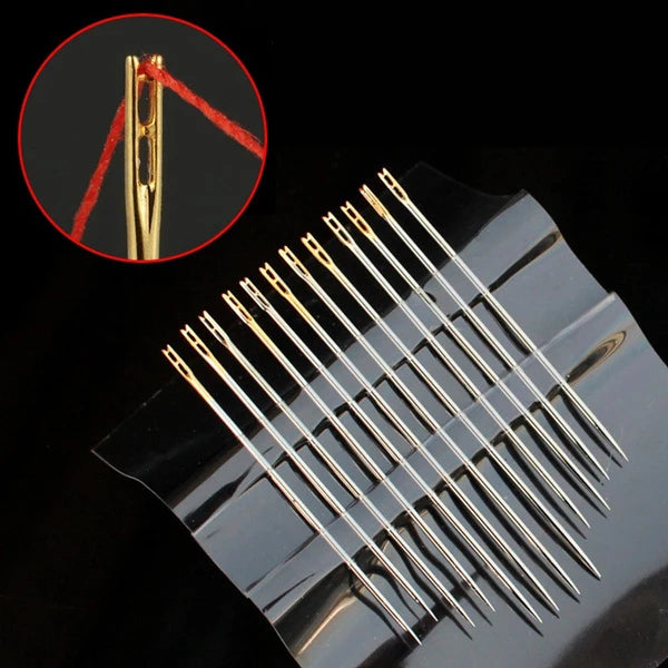 A precision self-threading sewing needle kit showing a single needle and red thread on a dark surface.
