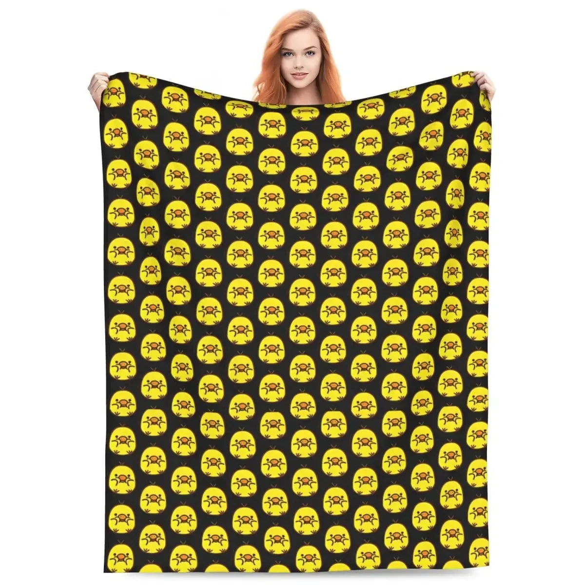 A black and yellow patterned plush throw blanket featuring cartoon faces.