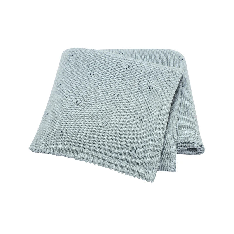Light blue knitted baby blanket with small embroidered stars