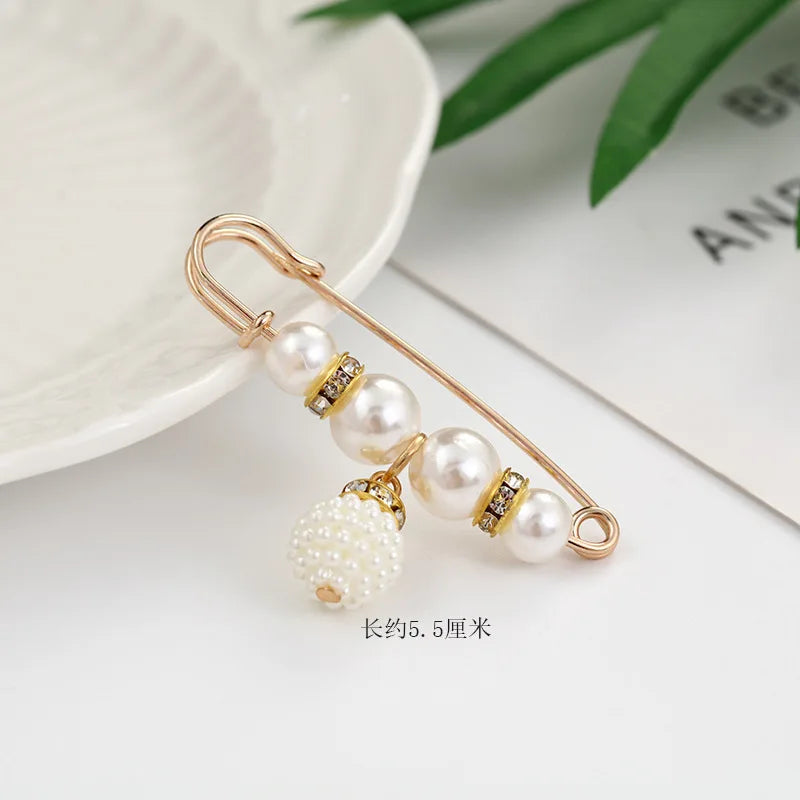 Gold-toned adjustable pearl brooch featuring multiple strands of pearls and small diamond accents