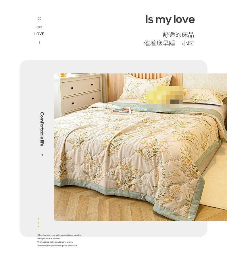 A beige and gold patterned quilt is displayed on a bed, suggesting comfort for dorms.