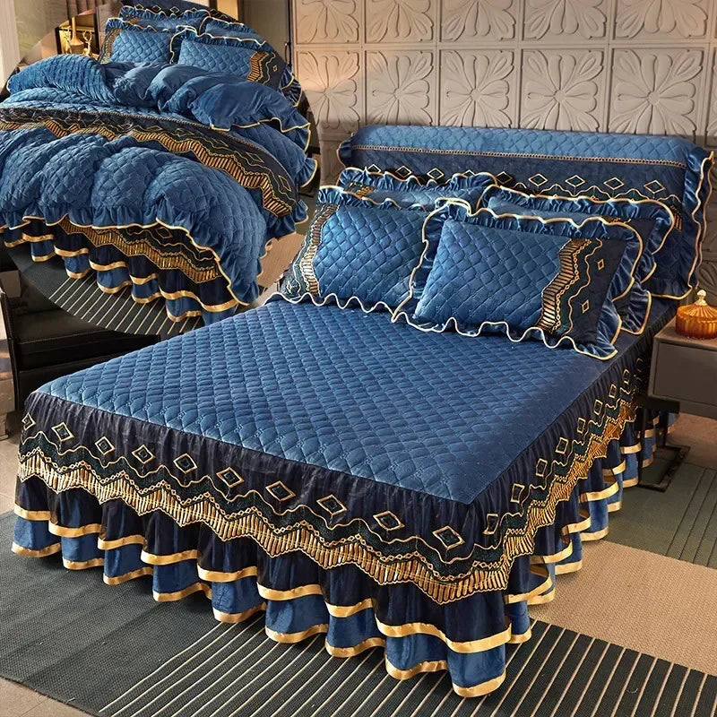 A navy blue velvet bed skirt with gold trim and diamond pattern is displayed on a bed.