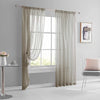A pair of light beige sheer curtains hanging in a window frame in a modern living room setting.
