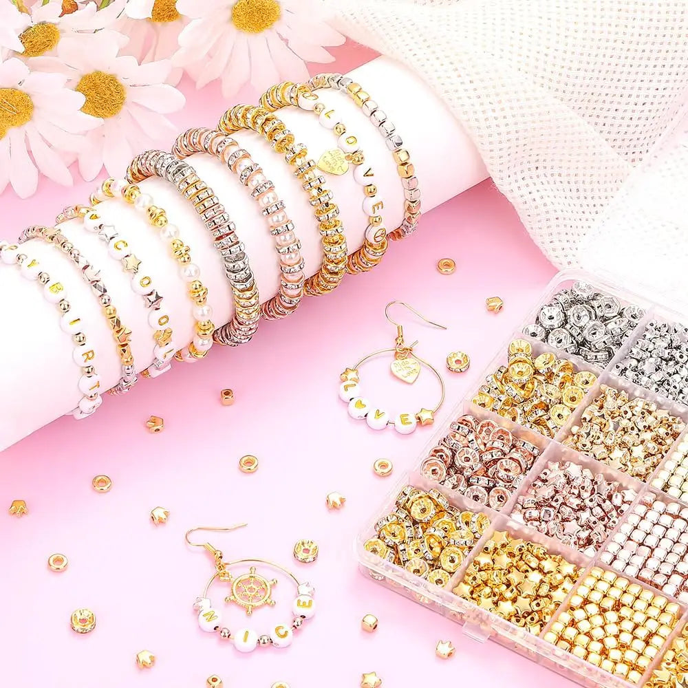 A display of various gold and silver acrylic beads, including bracelets and earrings, arranged in small compartments.