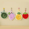 Four adorable floral coral fleece hanging hand towels shaped like watermelon, strawberry, pineapple, and grape.