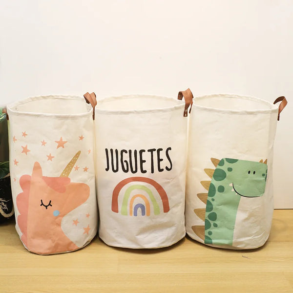 Three white fabric storage baskets with cartoon animals and rainbows for baby or dirty clothes.
