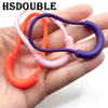 A hand holds several U-shaped zipper pull straps in mixed colors including orange, pink, and purple.