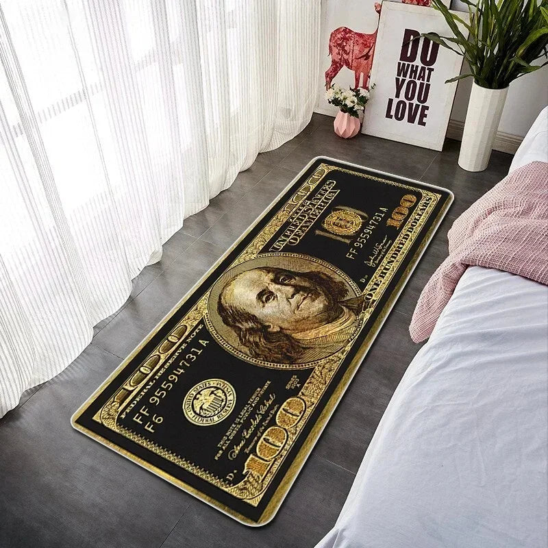A rectangular gold and black decorative floor mat featuring a portrait of a man on US currency.