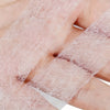 Clear fusible hem tape applied to a finger, showing the transparent adhesive material.