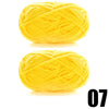 A ball of bright yellow thick velvet yarn for knitting and crochet