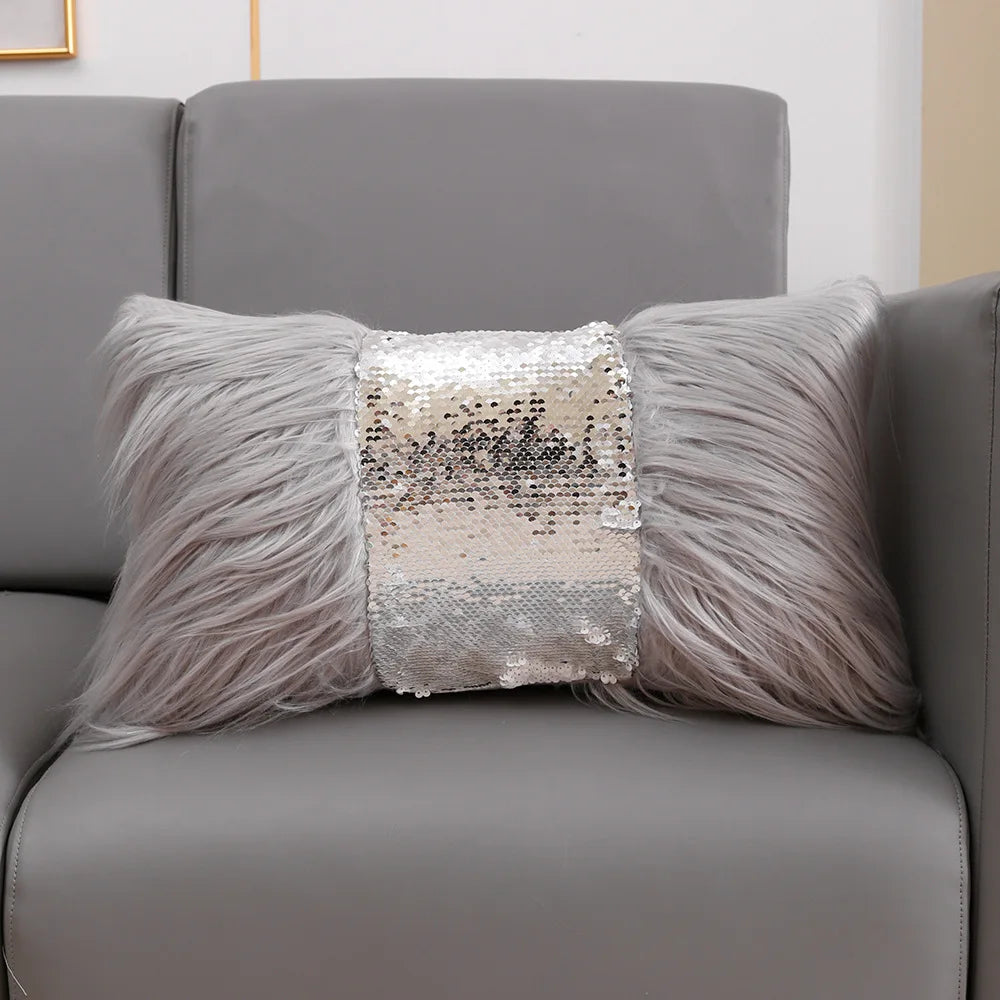 A silver sequin fur cushion cover placed on a gray sofa.
