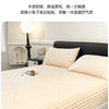 Close-up of thick, light beige fitted bed sheets with a ribbed texture, showing features like softness and warmth.