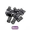 A pile of black adjustable plastic paracord buckle bracelets.