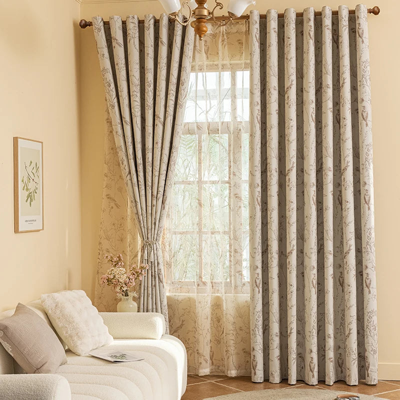 Light beige blackout printed curtains with striped fabric hanging in a window.