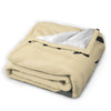 A tan fleece throw blanket featuring a Totoro character design, folded and displayed.
