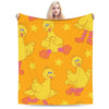 A yellow cartoon bird character from Sesame Street is featured on a bright orange blanket.