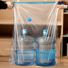 Clear plastic storage bags are being used to compress and store blue water bottles.