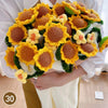 Hand knitted floral rose bouquet arrangement with yellow and orange flowers and green leaves