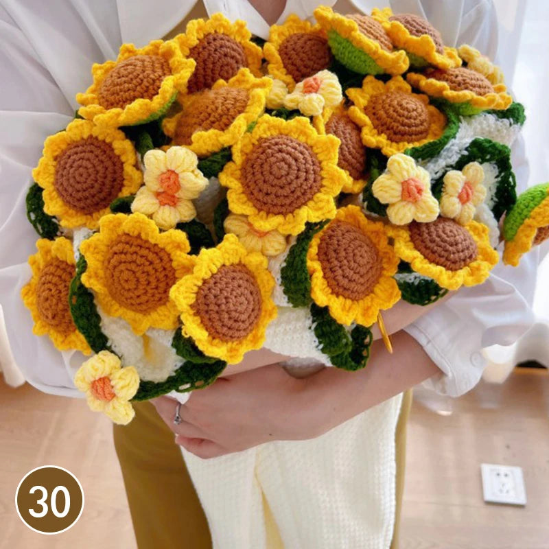 Hand knitted floral rose bouquet arrangement with yellow and orange flowers and green leaves