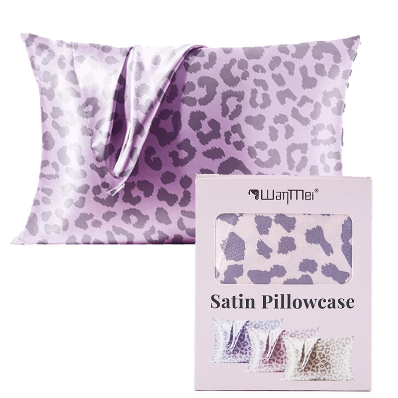 A purple leopard print satin pillowcase with a silky drape shown next to its packaging.