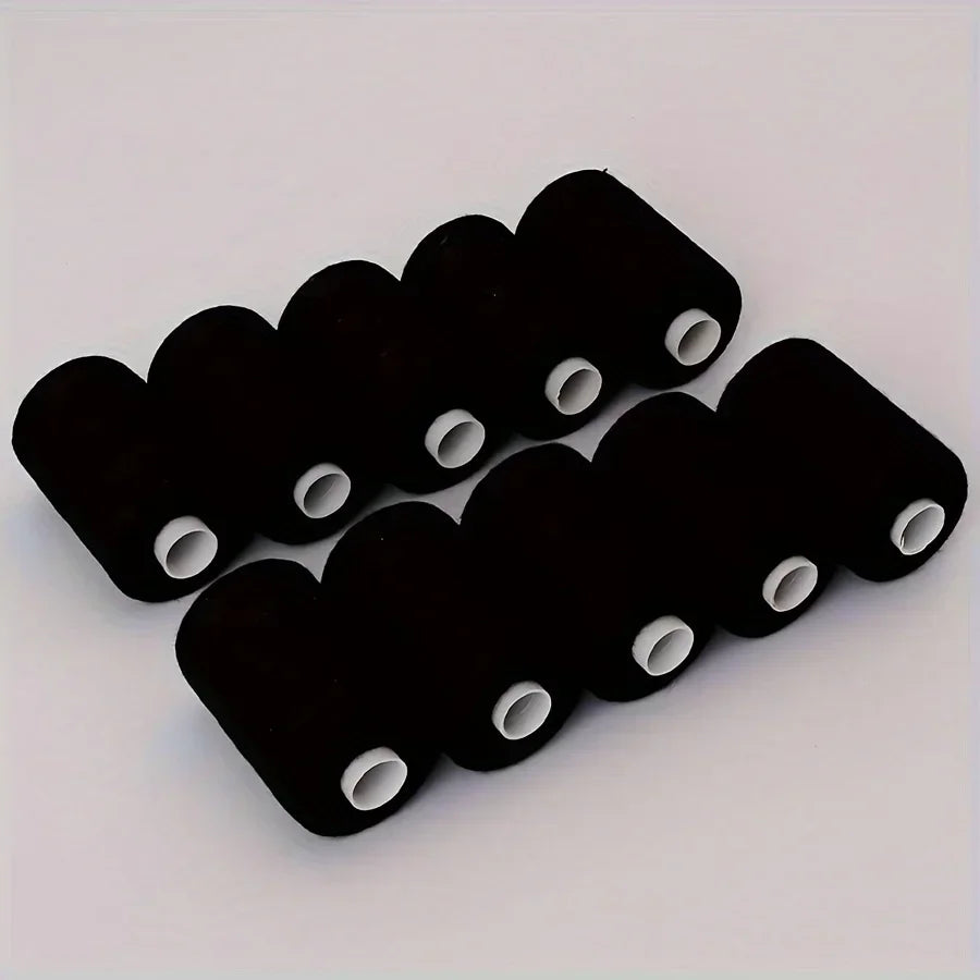A pack of ten black polyester sewing threads arranged in a row on a white surface.