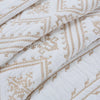 Close-up of white Nordic cotton embroidered bedding featuring a geometric pattern in beige thread.