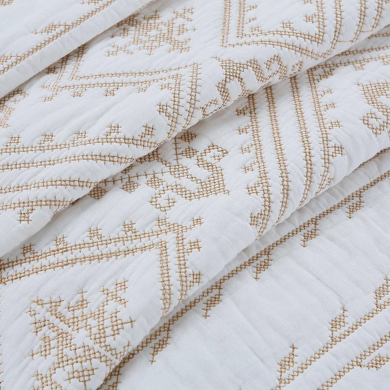 Close-up of white Nordic cotton embroidered bedding featuring a geometric pattern in beige thread.