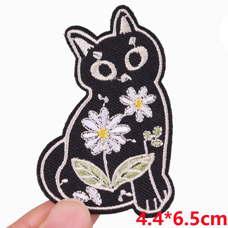 Black embroidered cat patch with white floral details