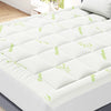 White Viscose Bamboo mattress topper with green leaf pattern shown on a bed.