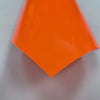 A bright orange, triangular sheet of 3D puff heat transfer vinyl for apparel.