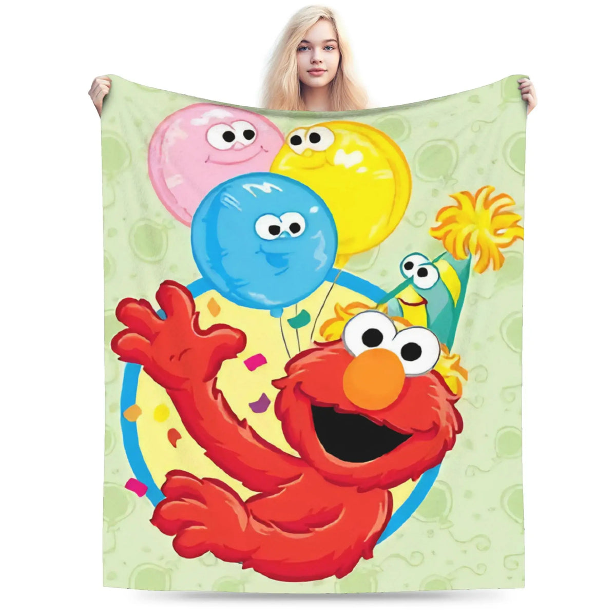 A person is holding a cartoon image of Elmo and Friends on a green flannel throw blanket.