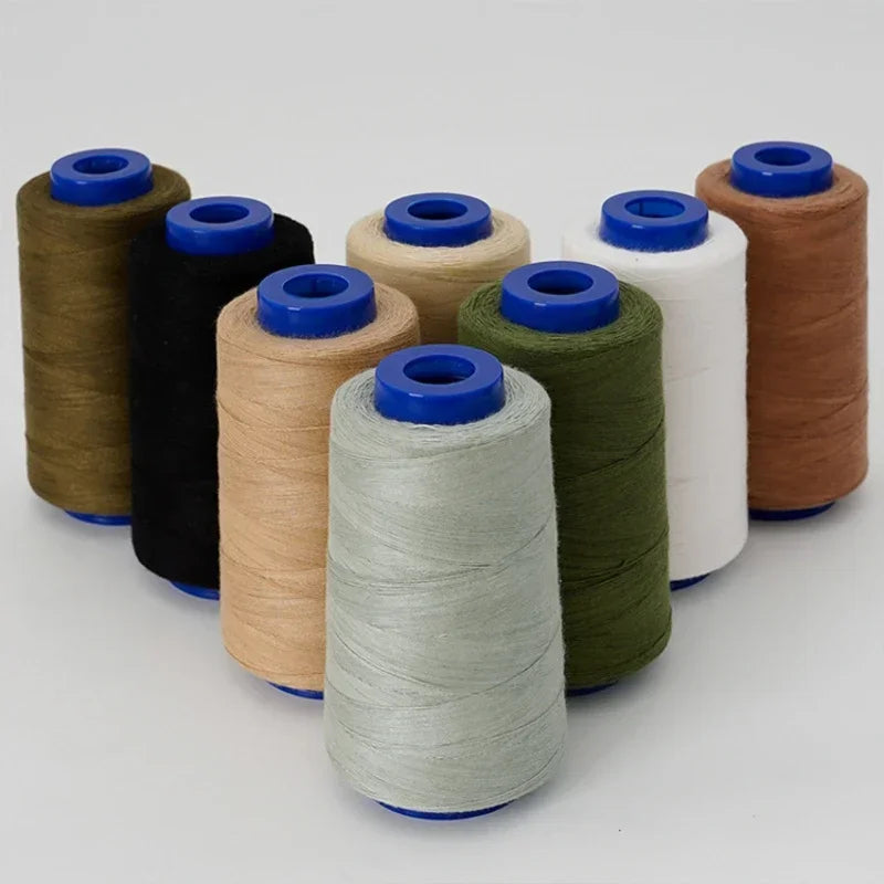 A collection of spools of heavy-duty waterproof sewing thread in various colors including brown, black, beige, green, and whi