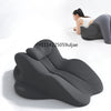 A dark gray ergonomic memory foam reading pillow is shown supporting a person's back and head for reading.